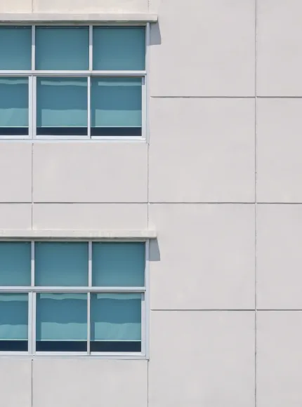 architecture-background-of-glass-windows-on-large-2025-03-10-18-46-42-utc Minimal geometric architecture background of glass windows on large square concrete tiles wall of office building